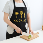 Person slicing vegetables while wearing waterproof cooking apron in kitchen Qatar