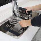 Expandable dish rack being cleaned under running water for easy maintenance in kitchens Homesouq Qatar