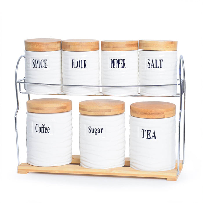 Minimalist white ceramic jar set with wooden lids arranged on rack for organized kitchen storage Qatar