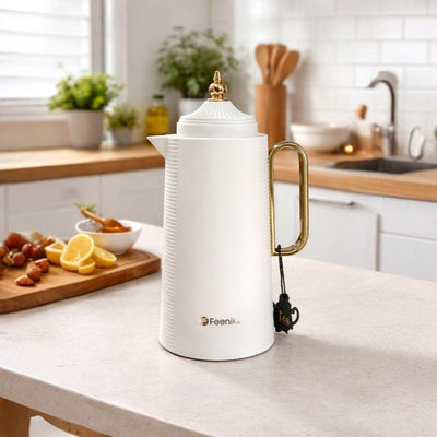 White vacuum flask placed on kitchen counter, modern insulated flask for everyday use Qatar