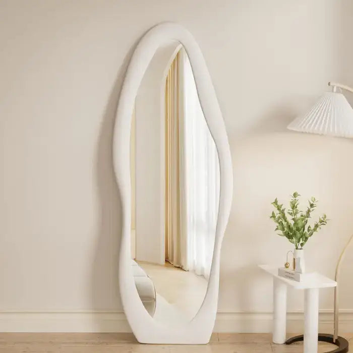 Modern oval full length mirror styled with minimal furniture and soft lighting home decor Homesouq Qatar