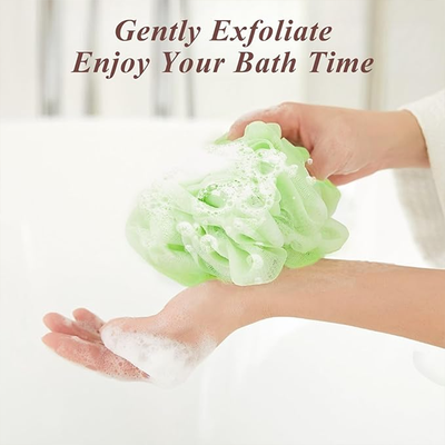 green bath sponge creating rich foam while gently exfoliating skin during shower routine Qatar