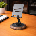 Metal mobile stand placed on wooden desk showing adjustable viewing angle in Homesouq Qatar