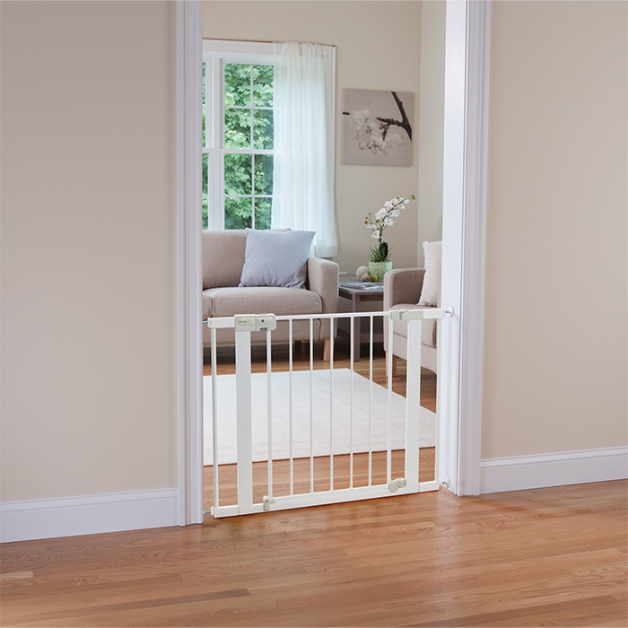 Metal safety gate installed in doorway to keep babies safe indoors in Qatar