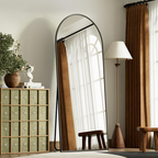 Arched floor standing mirror with metal stand near window and cabinet Qatar