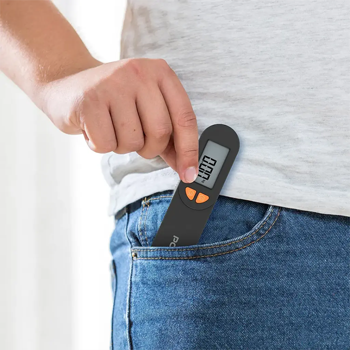 Pocket-size digital luggage scale placed in jeans pocket for easy travel use Qatar