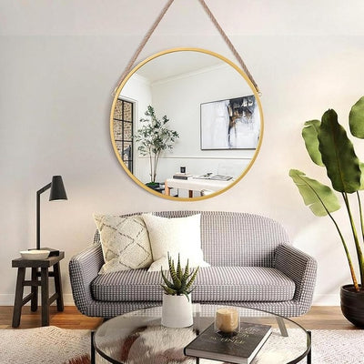 Decorative hanging mirror above sofa with plant and modern home decor interior circle mirror Qatar