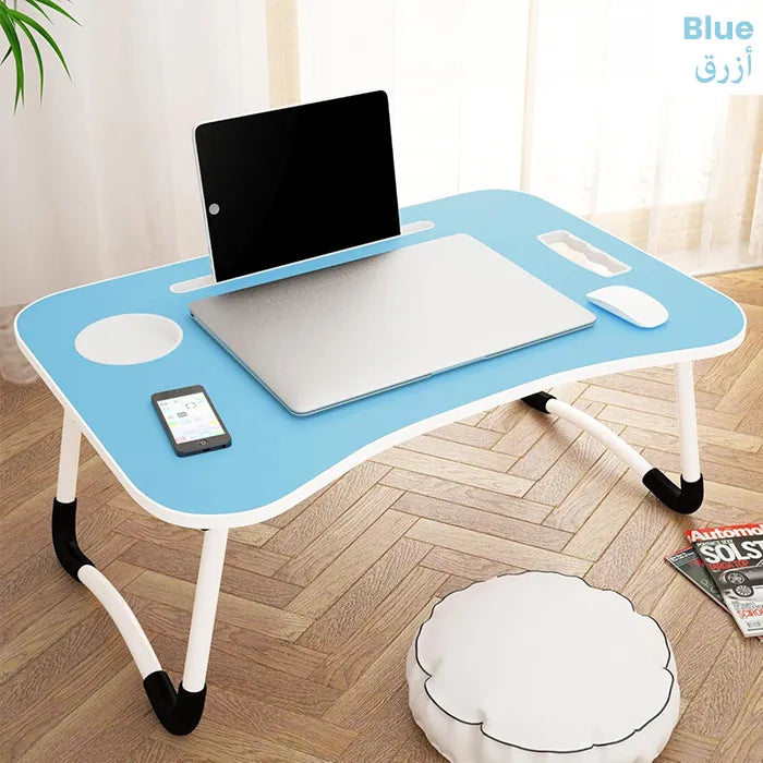 Foldable laptop desk placed on bed with accessories for study and work Homesouq Qatar