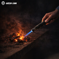 Butane torch lighter producing blue flame igniting charcoal for grilling in Homesouq Qatar