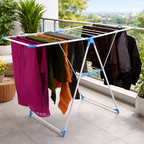 Clothes drying rack with garments drying on balcony railing showing practical cloth drying stand usage Qatar