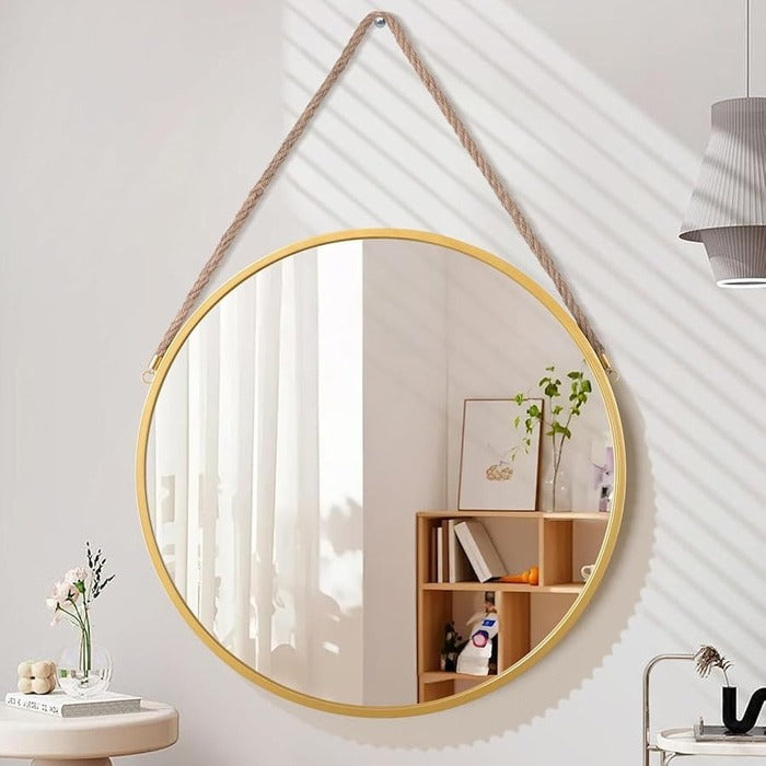 Gold frame hanging mirror with rope mounted on wall for minimalist home decor styling Qatar