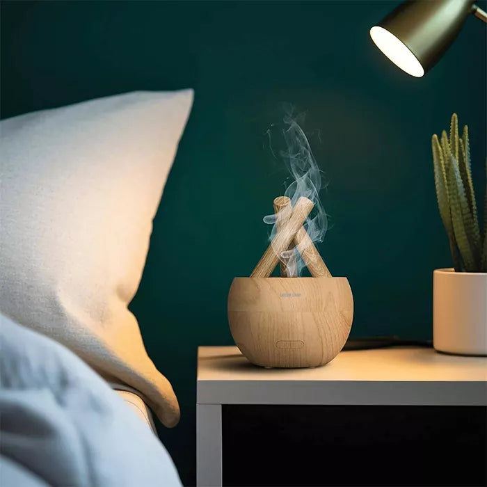 Flame diffuser emitting mist on bedside table with soft lighting and modern bedroom decor in Qatar Homesouq Qatar