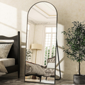 Black frame standing mirror beside bed in classic bedroom setting Qatar