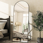 Black frame standing mirror beside bed in classic bedroom setting Qatar
