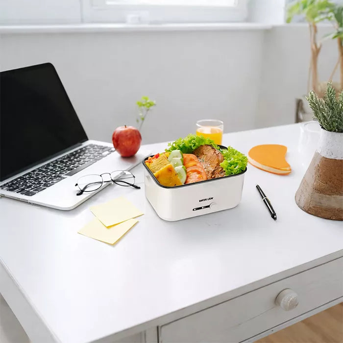 Green Lion electric lunch box filled with healthy meal placed on office table setup in Homesouq Qatar