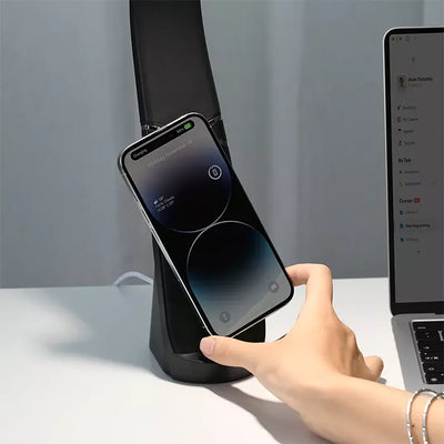 Green Lion LED desk lamp with wireless charging holding smartphone on desk Qatar Homesouq Qatar