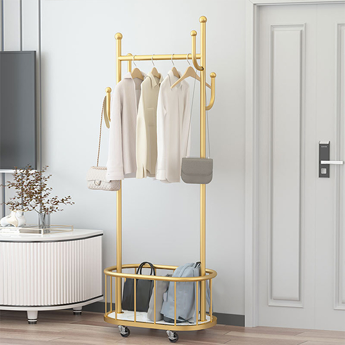 Gold hanging rack cloth hanger stand with clothes displayed in modern home interior Qatar