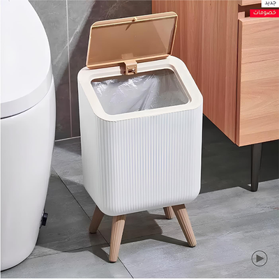 Compact trash bin placed beside toilet for bathroom use in Qatar