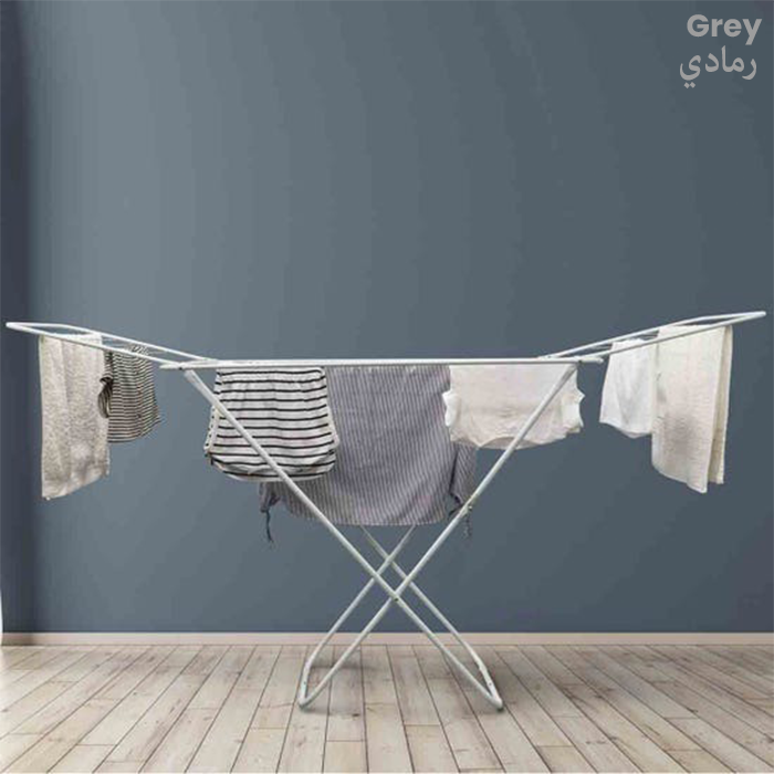 Foldable clothes drying rack with laundry hanging in a modern indoor room Qatar