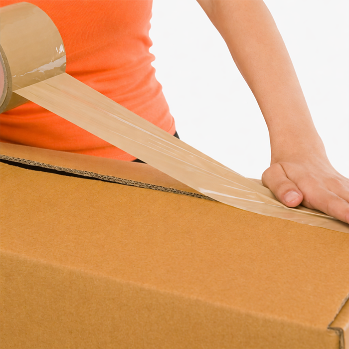 Packing tape being applied on cardboard box for secure sealing in Qatar 