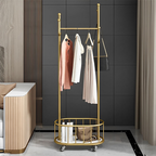 Elegant gold clothes rack cloth stand with hanging bar and storage basket placed in modern living room Qatar