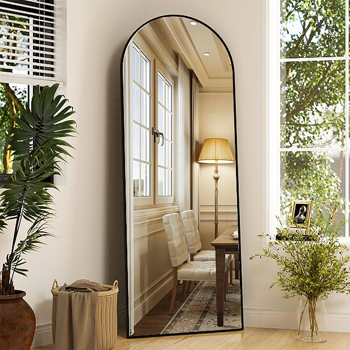 Full length mirror leaning against wall in bright dining area interior Qatar