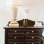 Compact bakhoor burner on wooden table with lamp and phone in room setup Qatar homesouq Qatar