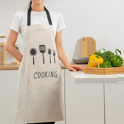 Unisex chef apron worn in kitchen with waterproof fabric and towel sides in Qatar
